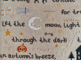 Halloween poem and motifs in the 'Tis the Night cross stitch pattern with a moon, jack-o-lantern broom, and part of a poem.